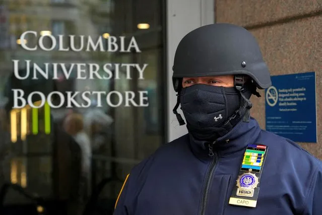 An NYPD officer stands guard as demonstrators gather outside of Columbia University to demand a ceasefire and the end of Israeli attacks on Gaza, during the ongoing conflict between Israel and the Palestinian Islamist group Hamas, during a protest in New York, on April 20, 2024. (Photo by Adam Gray/Reuters)