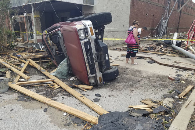 A car lies on its side after being knocked over during a tornado that tore through downtown Sulphur, Okla., Sunday, April 28, 2024. (Photo by Ken Miller/AP Photo)