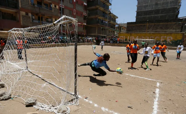 A female goalkeeper saves the ball at the Mathare Environmental Conservation Youth Center during a soccer match to celebrate the International Women's day in Nairobi, Kenya, March 8, 2017. (Photo by Thomas Mukoya/Reuters)