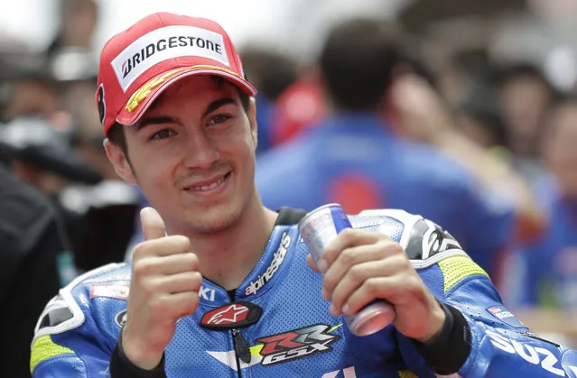 Spain's Maverick Vinales gestures after clocking the second fastest time for Sunday's Spanish Motorcycling in Montmelo, Spain, Saturday, June 13, 2015. The Catalunya Grand Prix will take place on Sunday in Montmelo. (AP Photo/Manu Fernandez)