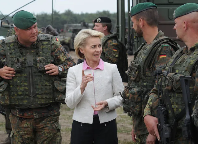 German Defense Minister Ursula von der Leyen speaks with German soldiers after the NATO Noble Jump exercise on a training range near Swietoszow Zagan, Poland, Thursday, June 18, 2015. (AP Photo/Alik Keplicz)