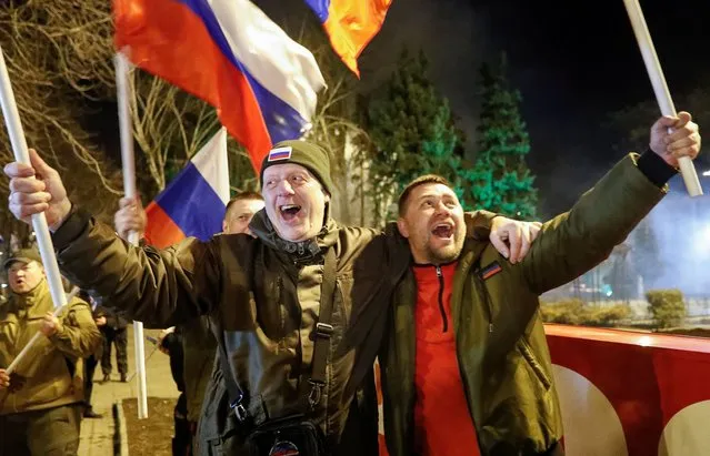 Pro-Russian activists react in a street, after Russian President Vladimir Putin signed a decree recognising two Russian-backed breakaway regions in eastern Ukraine as independent entities,in the separatist-controlled city of Donetsk, Ukraine on February 21, 2022. (Photo by Alexander Ermochenko/Reuters)