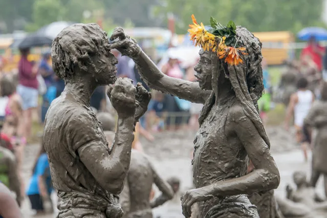 Caprise Debose, left, and Kaliyah Watson, of Westland, play together during the annual Mud Day at Nankin Mills Park in Westland, Mich. on Tuesday, July 7, 2015. (Photo by David Guralnick/The Detroit News via AP Photo)