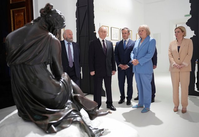 In this pool photograph distributed by Russian state agency Sputnik, Russia's President Vladimir Putin tours an exhibition commemorating the 225th birthday of poet Alexander Pushkin at the State Museum of Tsarskoye Selo in Pushkin early on June 6, 2024. (Photo by Alexander Zholobov/AFP Photo)
