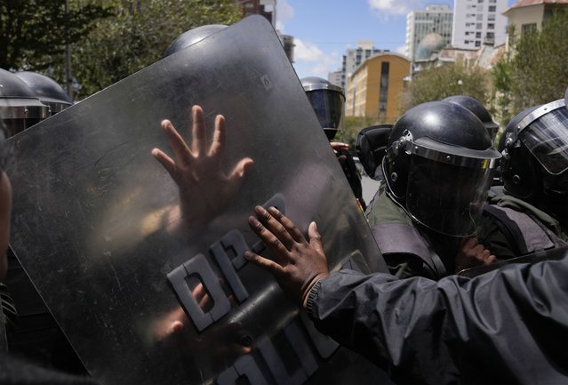 Protesters clash with police attempting to keep them from reaching the Education Ministry in La Paz, Bolivia, Monday, March 20, 2023. Teachers are demanding higher pay and protesting the new curriculum at public schools. (Photo by Juan Karita/AP Photo)