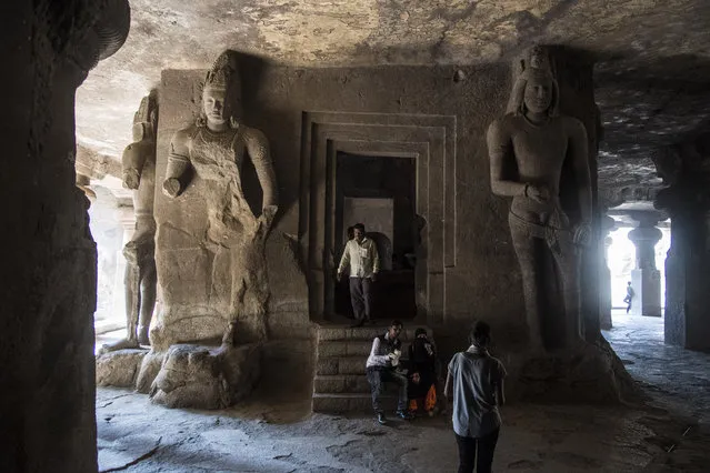 People walk around and admire the large carvings in the Elephanta Caves, a UNESCO World Heritage Centre and contain a collection of rock art linked to the cult of Shiva, on Elephanta Island in Navi Mumbai, India on Tuesday May 10, 2016. (Photo by Jabin Botsford/The Washington Post)