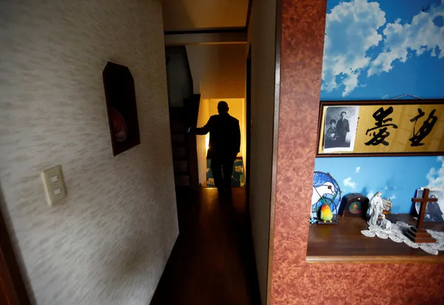 Seiichiro Nishimoto, CEO of Shelter Co., walks into a basement where the model room for the company's nuclear shelters is installed during an interview with Reuters in Osaka, Japan April 26, 2017. With nearby North Korea increasing its show of power day by day with missile launches and nuclear tests, people in Japan are preparing for the worst by building private nuclear shelters, Reuters reports. In Japan, small companies offering custom-built underground nuclear shelters claim a boost in sales in recent weeks. Oribe Seiki Seisakusho, based in Kobe, western Japan, told Reuters it typically receive six shelter-building orders a year, but has received eight orders in April alone. Another company, Earth Shift, says it has received 10 times more inquiries for quotes this year. A Reuters photographer recently took a tour of Shelter Co.’s sales model, built in the Osaka home of the company’s CEO, Seiichiro Nishimoto. The air-tight basement features an anti-blast door, an anti-radiation air purifier, a tunnel exit, a Geiger counter, a television, gas masks, and other emergency supplies. Perhaps anticipating that residents confined underground would like to be reminded of a peaceful radiation-free world, the shelter’s ceiling is painted in bright blue skies, and has wallpaper depicting a tropical palm tree-lined beach. Nishimoto claimed in a 2009 interview with AFP that his business had seen a record number of sales in the days between the announcement and launch of a North Korean intercontinental ballistic missile over Japan at the time. (Photo by Kim Kyung-Hoon/Reuters)