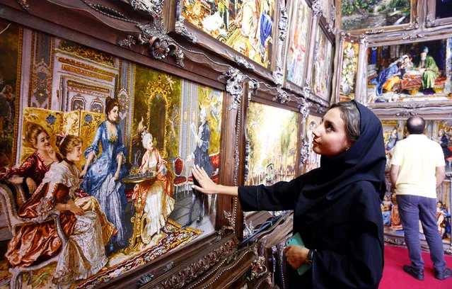 An Iranian woman visits the 28th handmade carpet exhibition at the international exhibition complex, in Tehran, Iran, 26 August 2019. The exhibition runs until 31 August. Carpet industry in Iran was affected by sanctions and export restrictions, as recent figures released in March showed a 30 percent drop in carpet exports. (Photo by Abedin Taherkenareh/EPA/EFE)