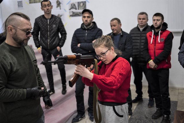 Ukrainian civilians receive weapons training in Lviv, Western Ukraine, Saturday, March 19, 2022. (Photo by Bernat Armangue/AP Photo)