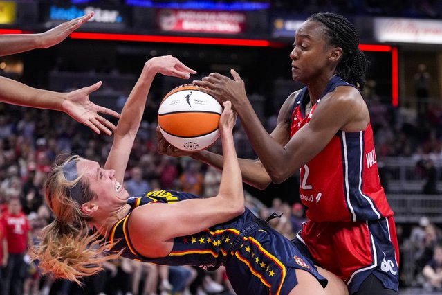 Indiana Fever guard Lexie Hull, left, forces a jump ball with Washington Mystics guard Shatori Walker-Kimbrough (32) in the second half of a WNBA basketball game in Indianapolis, Wednesday, July 10, 2024. (Photo by Michael Conroy/AP Photo)