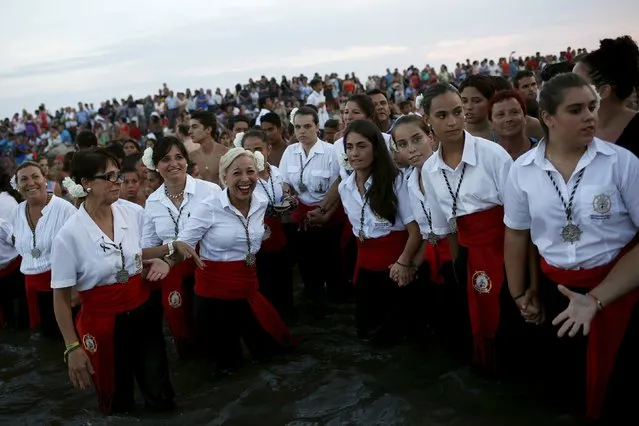 People in traditional costumes take part in the procession of the El Carmen Virgin being carried into the sea in Malaga July 16, 2015. (Photo by Jon Nazca/Reuters)