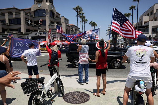 Pro-Trump supporters react as a car drives by during a demonstration in support of former President Donald Trump, who was shot the previous day in an assassination attempt during a rally in Pennsylvania, in Huntington Beach, California on July 14, 2024. (Photo by Etienne Laurent/Reuters)