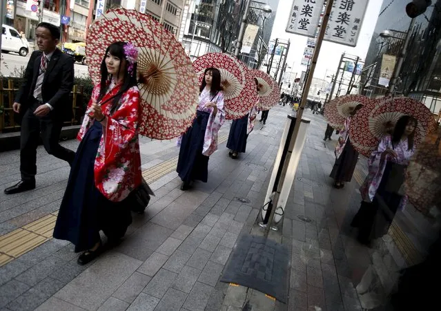 Women in Kimono holding an umbrella walk on a street at Ginza shopping district in Tokyo, Japan, March 31, 2016. (Photo by Yuya Shino/Reuters)