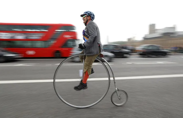 A participant in The Tweed Run cycle ride crosses Westminster Bridge on his Penny Farthing in London, Britain, May 6, 2017. (Photo by Peter Nicholls/Reuters)