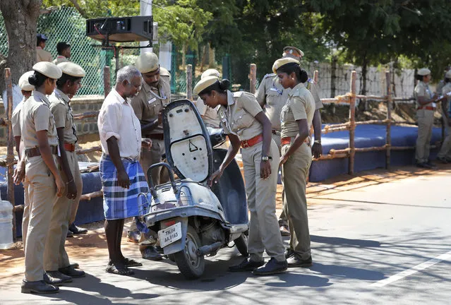 Police officers check a vehicle at the entrance to Mamallapuram, where Indian Prime Minister Narendra Modi and Chinese President Xi Jinping will hold their first meeting and dinner in southern India, Friday, October 11, 2019. Xi is coming to India to meet with Modi on Friday, just weeks after Beijing supported India's rival Pakistan in raising the issue of New Delhi's recent actions in disputed Kashmir at the U.N. General Assembly meeting. (Photo by Manish Swarup/AP Photo)