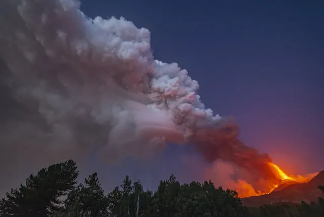 Smoke billows from the Mt Etna volcano as seen from Linguaglossa, Sicily, Monday, August 9, 2021. Europe's most active volcano remains active scattering ashes around a vastly populated area on its slopes. (Photo by Salvatore Allegra/AP Photo)