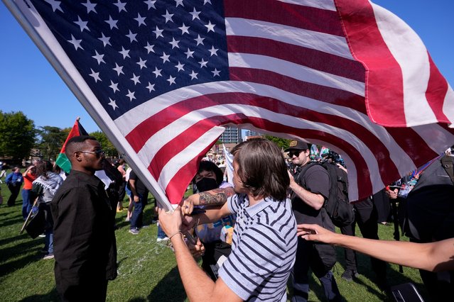 Demonstrators clash with counter protesters over the flag at a rally in Union Park during the Democratic National Convention Wednesday, August 21, 2024, in Chicago. (Photo by Alex Brandon/AP Photo)