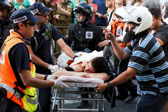 A participant of an annual gay pride parade is treated after an Orthodox Jewish assailant stabbed and injured six participants in Jerusalem on Thursday, police and witnesses said July 30, 2015. (Photo by Carsten Seibold/Reuters)