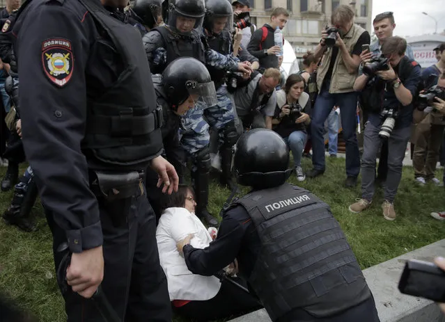 Police detain a protester during a demonstration in downtown Moscow, Russia, Monday, June 12, 2017. (Photo by Pavel Golovkin/AP Photo)