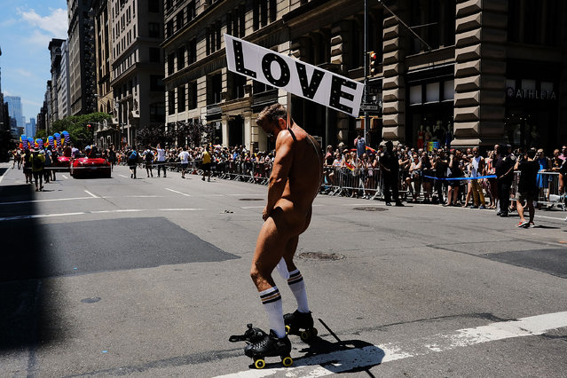 People march down 5th Ave. in the annual New York Gay Pride Parade, one of the oldest and largest in the world on June 25, 2017 in New York City. Thouands cheered as members of LGBT community danced and marched under a bright summer sun. Many participants carried political themed signs as President Trump's adminstration has angered some in the LGBT community. (Photo by Spencer Platt/Getty Images)