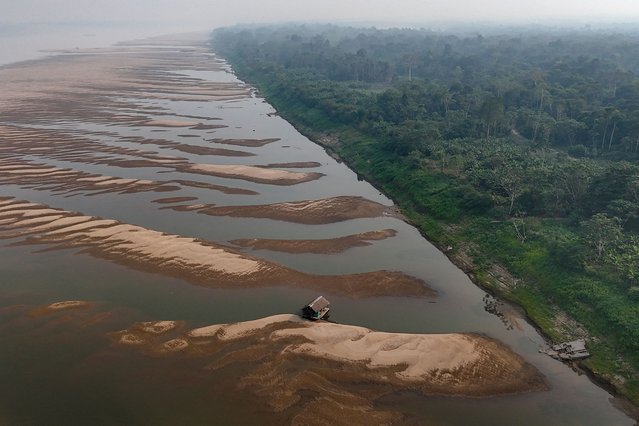 Aerial view of sandbanks on the Madeira River, in front of the city of Humaitá, Amazonas state, northern Brazil, taken on September 4, 2024. The 2024 northern summer saw the highest global temperatures on record, beating 2023's high and making this year likely Earth's hottest ever recorded, the EU's climate monitor said on September 6, 2024. The data from the Copernicus Climate Change Service followed a season of heatwaves around the world that scientists said were intensified by human-driven climate change. (Photo by Michael Dantas/AFP Photo)