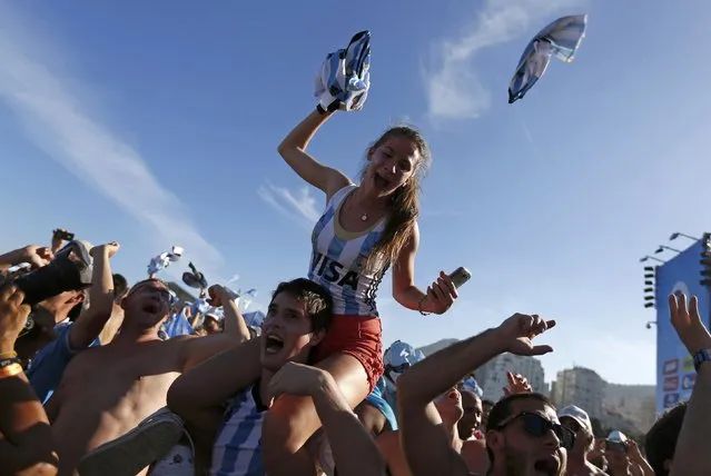Argentine soccer fans celebrate at the end of the 2014 World Cup quarter-finals between Argentina and Belgium at Copacabana beach in Rio de Janeiro, July 5, 2014. (Photo by Pilar Olivares/Reuters)