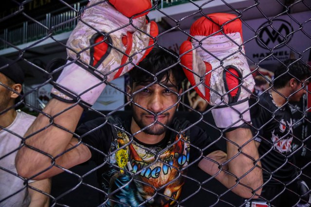 An Afghan man looks on during a mixed martial arts class at a club in Kabul, Afghanistan, 27 August 2024. The Taliban administration has officially banned Mixed Martial Arts (MMA)/Free Fight, deeming it incompatible with Islamic teachings. It was announced by the Ministry for Promotion of Virtue and Prevention of Vice to the National Olympic and Physical Training Committee, citing concerns over violence and safety risks associated with the sport. The ban went into effect on 27 August, with some clubs being able to practice into the evening due to the time taken to communicate the edict across the country. Ahmadullah Vathiq, head of the Taliban's physical training, stated, “After research, it became clear that this sport has problems from the point of view of Sharia... it has no right to continue its activities in Afghanistan”. This ban adds to the growing list of restrictions imposed by the Taliban, including previous prohibitions on women participating in sports. (Photo by Samiullah Popal/EPA/EFE)