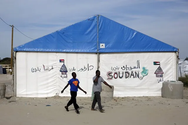 Two African migrants walk past a tent at “The New Jungle” camp in Calais, France, August 8, 2015. (Photo by Juan Medina/Reuters)