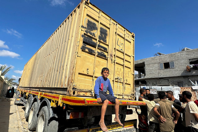 A Palestinian boy sits on a truck loaded with bodies of Palestinians killed in the Israeli military offensive after Israel returned them to Gaza but the health ministry refused to bury them before Israel discloses details about their names and the locations where they died, in Khan Younis in the southern Gaza Strip on September 25, 2024. (Photo by Mohammed Salem/Reuters)