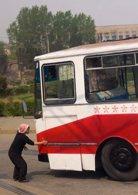  It is forbidden to enter Pyongyang with a dirty car, so after a long trip on the highway, the cars are the buses are cleaned before entering the town. It is a way to respect the town of the Leaders told my guide. (Photo by Eric Lafforgue/Exclusivepix Media)