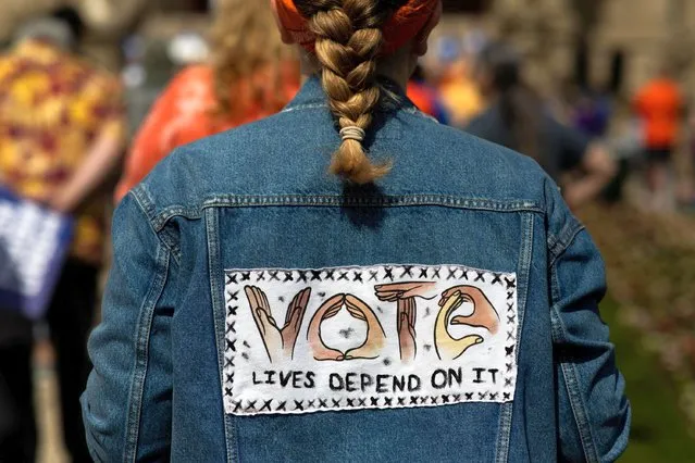 A young girl wears an embroidered jacket during a March for Our Lives rally for gun control in Lansing, Michigan, U.S., June 11, 2022. (Photo by Emily Elconin/Reuters)