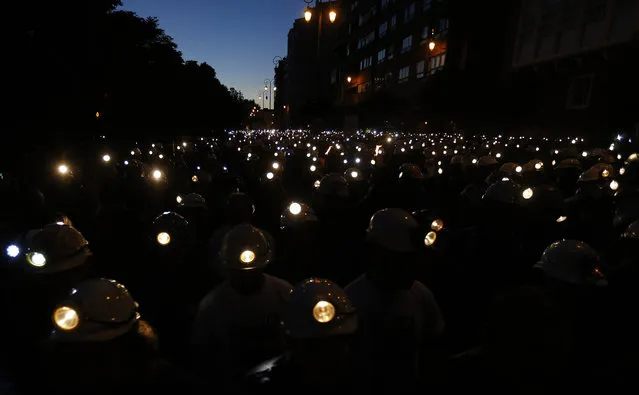 Coal miners demonstrate with their lamps lit through the streets of Leon, Spain, on June 12, 2012