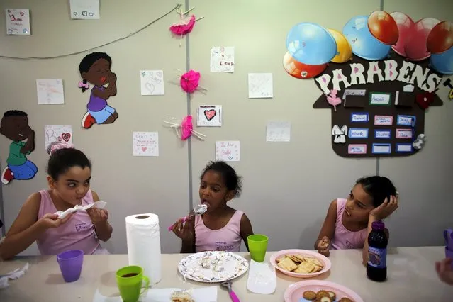 Young girls eat a lunch after taking ballet lessons at the New Dreams dance studio in the Luz neighborhood known to locals as Cracolandia (Crackland) in Sao Paulo, Brazil, August 14, 2015. (Photo by Nacho Doce/Reuters)