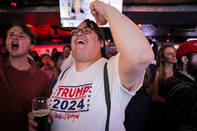 People react to early voting results during a watch party at the New York Young Republican Club watch party in New York City on November 6, 2024. (Photo by Andrew Kelly/Reuters)