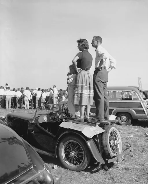 British MG sports cars were much in evidence on and off the track, at the road races for foreign cars at the Linden Airport in New Jersey, August 22, 1949. This family turned the back of their sporty little car into a grandstand to view the races. Several hundred foreign cars were spotted among those driven in by spectators. (Photo by Bob Wands/AP Photo)