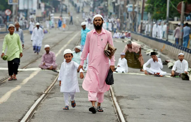 A Muslim man and his son make their way to Eid al-Fitr prayers to mark the end of the holy fasting month of Ramadan, in Kolkata, India, July 7, 2016. (Photo by Rupak De Chowdhuri/Reuters)