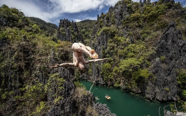 In this handout image provided by Red Bull, Gary Hunt of the UK dives from a rock pinnacle at the Small Lagoon on Miniloc Island during the second training session of the first stop of the Red Bull Cliff Diving World Series on April 11, 2019 at Palawan, Philippines. (Photo by Dean Treml/Red Bull via Getty Images)