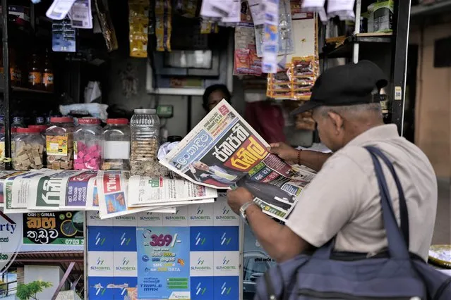 A man reads newspaper with news of Ranil Wickremesinghe's election in Colombo, Sri Lanka, Thursday, July 21, 2022. Sri Lanka's prime minister was elected president Wednesday by lawmakers who opted for a seasoned, veteran leader to lead the country out of economic collapse, despite widespread public opposition. (Photo by Rafiq Maqbool/AP Photo)