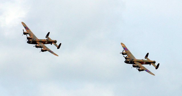 The world's two only properly functioning Lancaster bombers take to the skies above Eastbourne, Sussex, a display that hasn't been seen since the 1950's as part of the town's annual Eastbourne Air Show, on August 14, 2014. (Photo by Gareth Fuller/PA Wire)