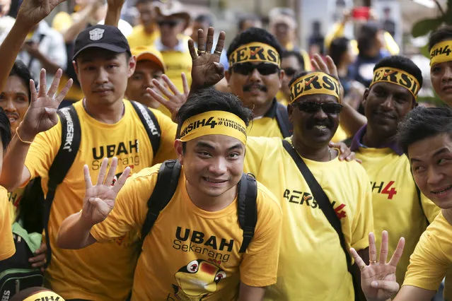 Supporters of pro-democracy group “Bersih” (Clean) pose for photographer before the start of a rally in Kuala Lumpur, Malaysia, Saturday, August 29, 2015. (Photo by Lai Seng Sin/AP Photo)