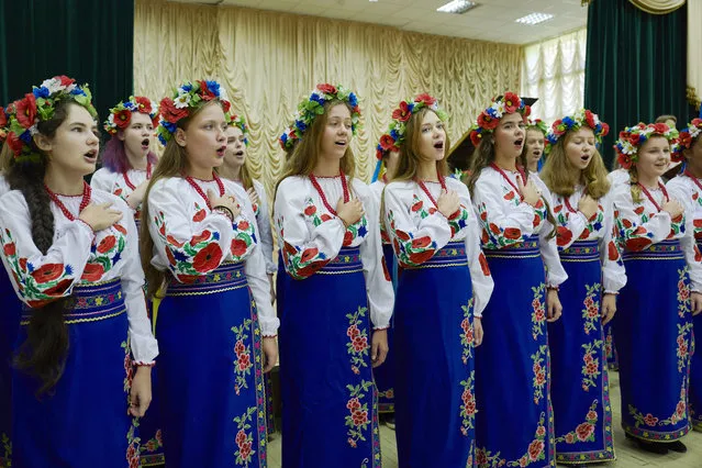 Music students sing the Ukrainian national anthem at the Special Music School Lysenko of Kiev as the first of september traditionally marks the start of the school year, on September 01, 2017 in Kiev, Ukraine. Four hundred and twenty three talented music students between the ages 5 to 18 study singing and music during eleven years at the Special Music School Lysenko of Kiev. Students and their relatives attend a concert, dressed up in traditional garnments, and bring flowers for the teachers. Many of the students were scouted by teachers during contests. Only the most talented singers and musicians are admitted in the prestigious music school. The school, administrated by the Ministry of Culture of Ukraine, has been created in times of the former Soviet Union. Ukrainian forces and Russia-backed separatists have agreed on August 25 on a new cease-fire for the start of the school year. (Photo by Pierre Crom/Getty Images)