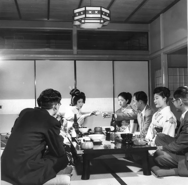 Geisha girls entertaining a group of men and ensuring their cups are kept full, circa 1955. (Photo by Three Lions)