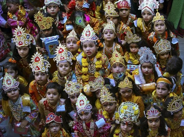 Children dressed as Hindu Lord Krishna pose during a fancy dress competition at a school on the eve of the Janmashtami festival in Mathura, India, September 4, 2015. (Photo by K. K. Arora/Reuters)