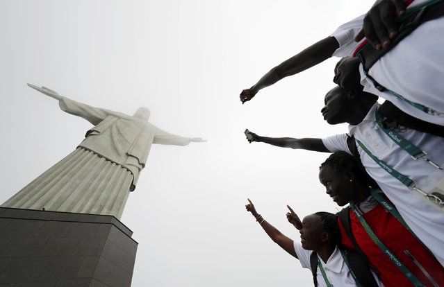2016 Rio Olympics, Christ the Redeemer on July 30, 2016. Members of the Olympic refugee team pose in front of Christ the Redeemer. (Photo by Kai Pfaffenbach/Reuters)