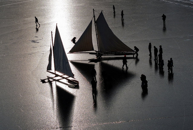 A drone view shows antique wooden ice sailing yachts, built during the late 1800s, maintained and sailed by members of the Hudson River Ice Yacht Club, as they prepare to sail on the frozen Hudson River near Athens, New York, U.S. January 25, 2025. (Photo by Mike Segar/Reuters)