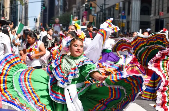 Participants are performing traditional folklore dance along Madison Avenue, New York City during the Mexican Day Parade on September 18, 2022. (Photo by Ryan Rahman/Pacific Press/Rex Features/Shutterstock)