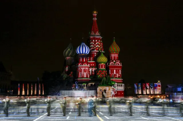 Members of the Southern Military District headquarters Band from Russia perform during the “Spasskaya Tower” international military music festival, with the St. Basil's Cathedral seen in the background, at Moscow's Red Square, Russia, September 10, 2015. (Photo by Maxim Shemetov/Reuters)