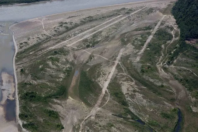 In this September 19, 2014 photo, clandestine airstrips are seen from a military helicopter in the Valley of the Apurimac, Ene and Mantaro River Valleys, or VRAEM, the world's No. 1 coca-growing region, in Pichari, Peru. The area has no radar coverage and the neighboring nations' air forces are limited so drug flights can only be intercepted on the ground. (Photo by Rodrigo Abd/AP Photo)