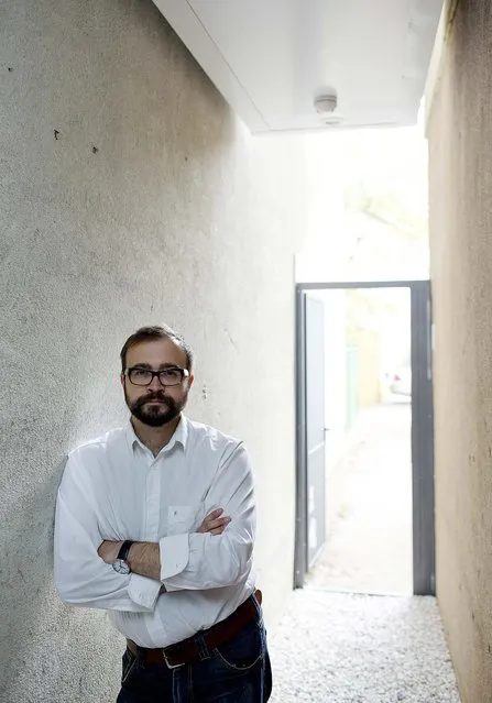 Jakub Szczesny, architect of the Keret House, stands in the alley under the home. (Photo by Andrea Meichsner/The New York Times)