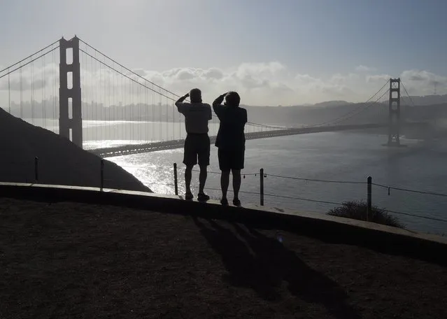 Tourists take pictures of the Golden Gate Bridge and the San Francisco skyline from the Marin County Headlines in Marin County, California, USA, 18 October 2016. Media reports on 16 September 2017 state lawmakers of California voted to make California what is called a “sanctuary state”. The vote effectively bans state and local police from asking arrested peoples' immigration status and also limits their cooperation with federal immigration officers. (Photo by John G. Mabanglo/EPA/EFE)
